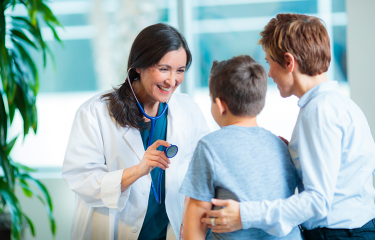 doctor from a graduate nursing program examines a child patient