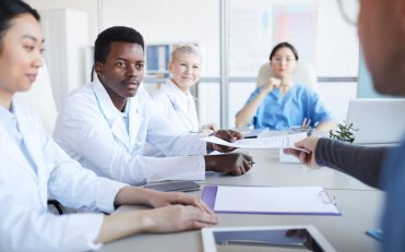 nurses around a discussion table