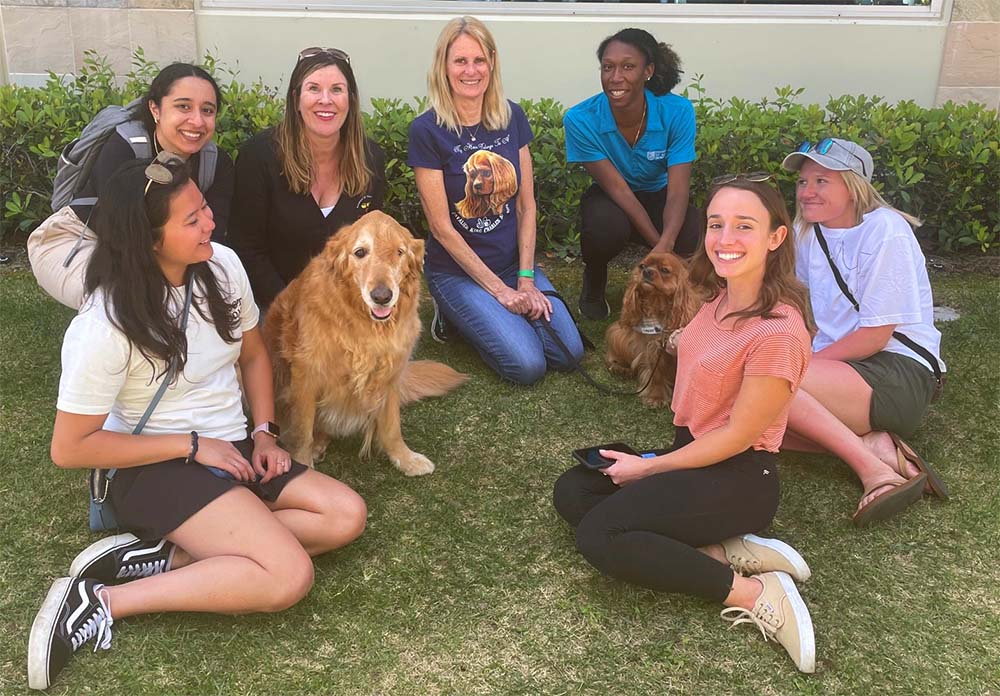 Members of the San Marcos COTAD group relax with therapy dogs
