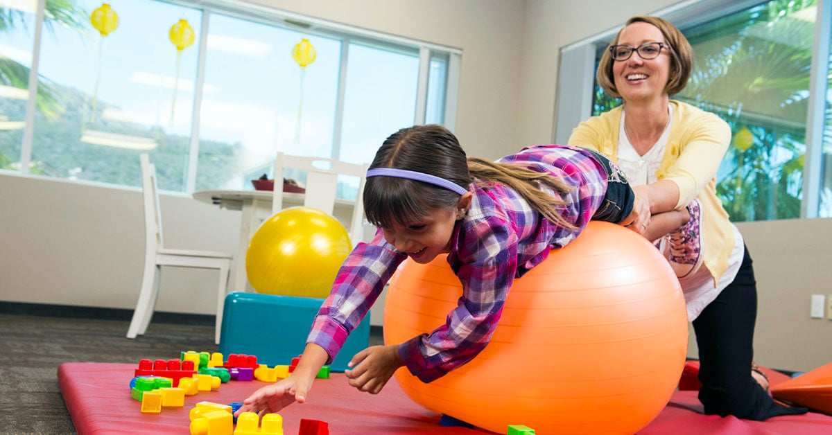 pediatric physical therapist working with a child