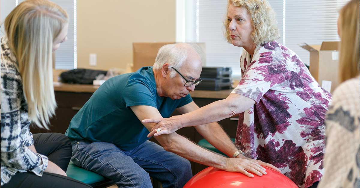 physical therapist working with a elderly patient