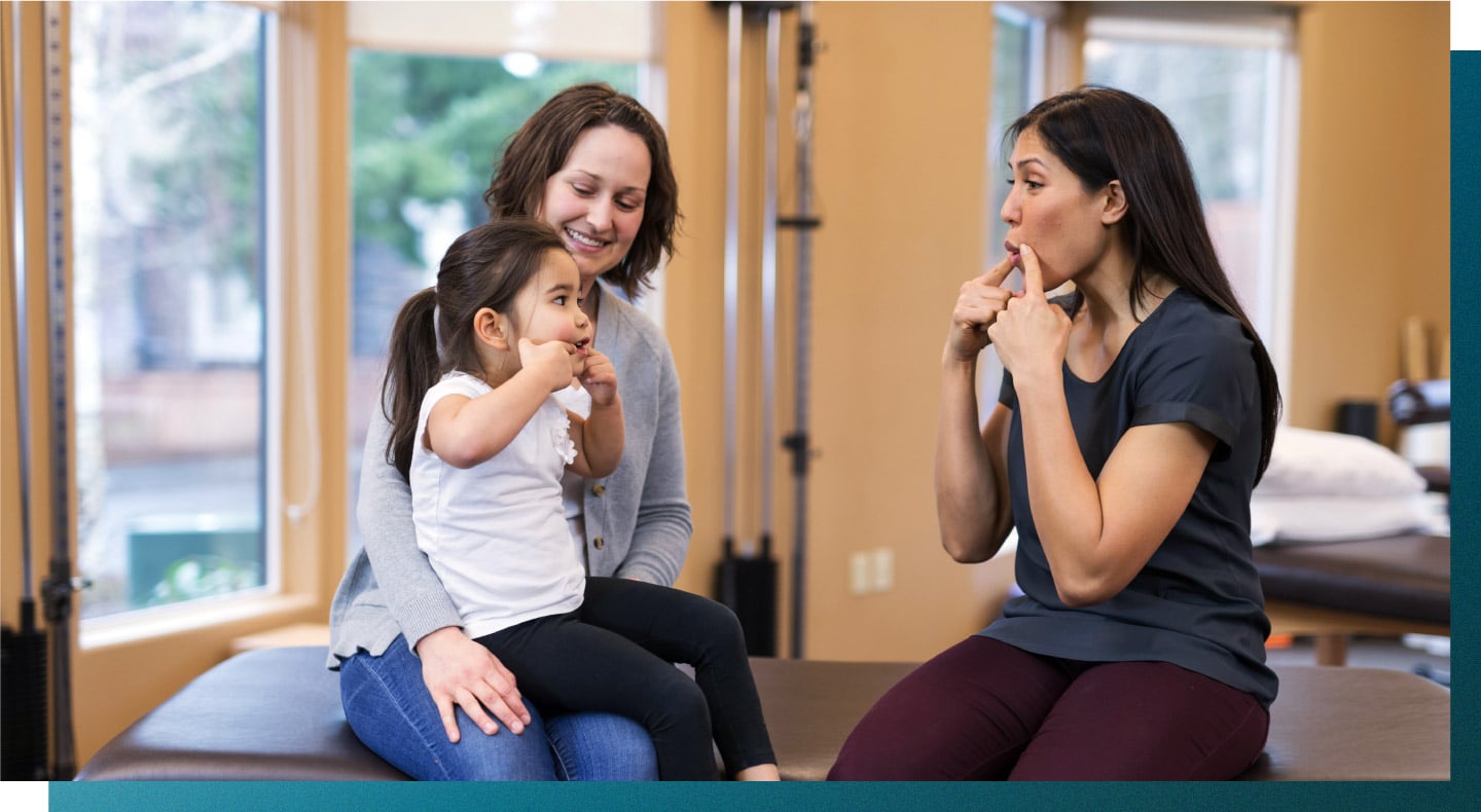 A USAHS student speech-language pathologists works with a child.