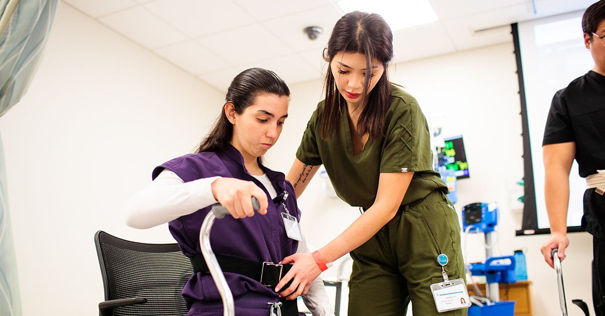 A USAHS OT student works with a patient.