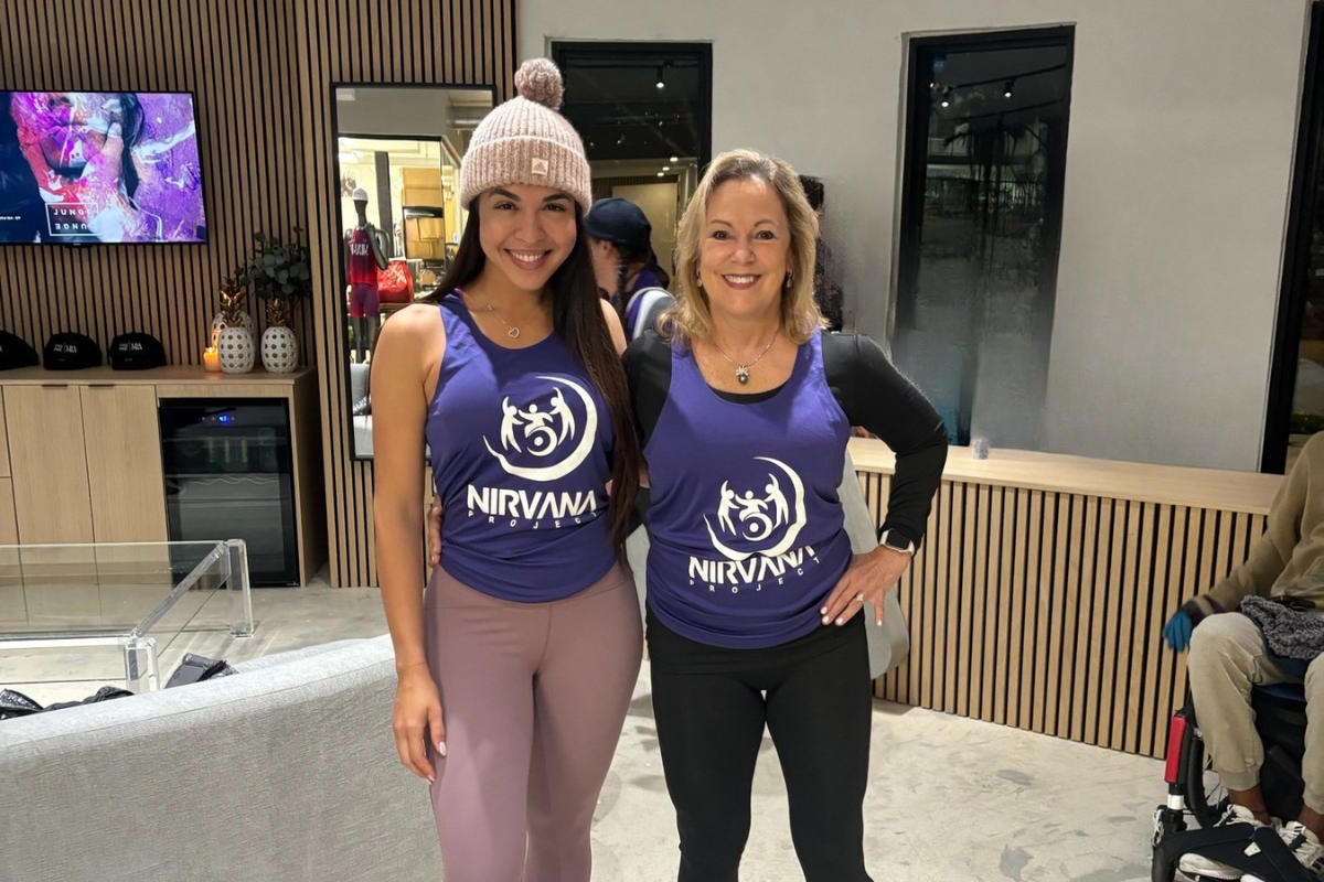 Two women standing next to one another.
